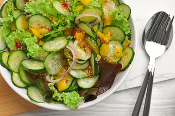 Delicious cucumber salad served on white wooden table, flat lay