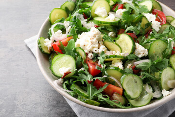 Plate of delicious cucumber salad on grey table, closeup