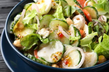 Bowl of delicious cucumber salad on table, closeup