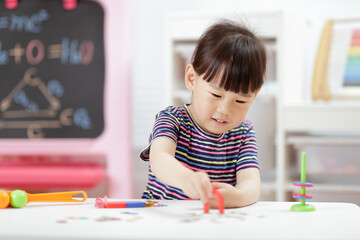 young  girl  play magical magnet experiments at home for homeschooling