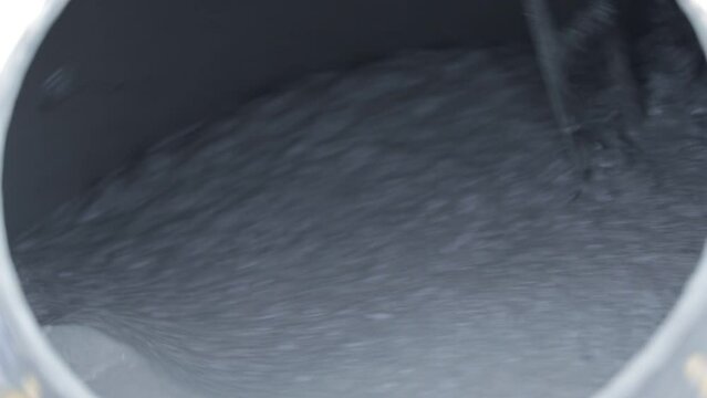 The inside of a concrete mixer full of cement
