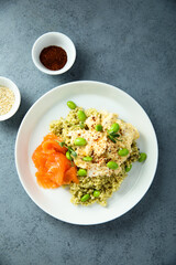 Scrambled eggs with couscous, salmon and beans