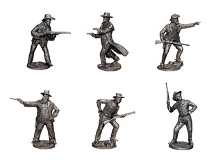 Cowboys. Gunslingers from the Wild West in different poses. Photo with tin figures.	
