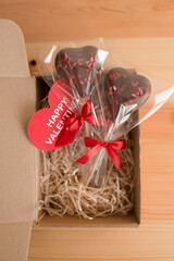 A box with chocolate hearts and a postcard