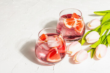 Non-alcoholic cocktail with grapefruit. An iced drink is served in glasses. St.Valentine's symbol