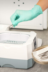 Hand disinfects tweezers with cleaning systems for medical instruments. Ultrasonic cleaner