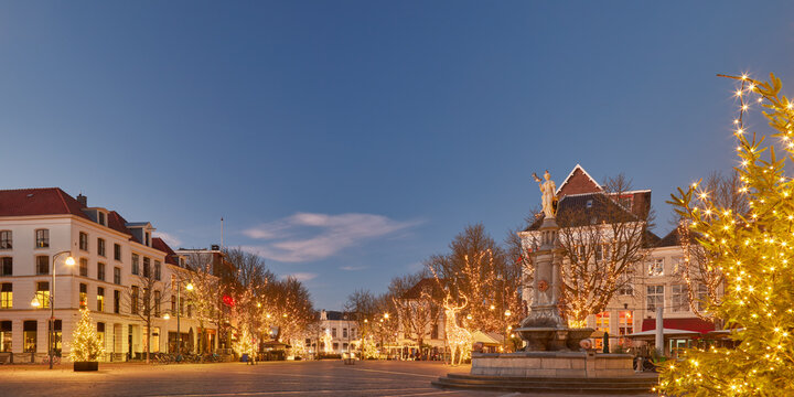 The central Brink square in the historic Dutch city Deventer in winter with christmas trees and decoration