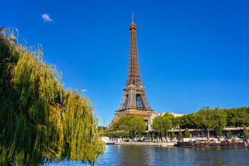 Fototapeta na wymiar Eiffel Tower by the Seine River in Paris at summer. France