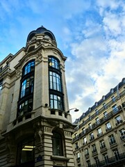 Fototapeta na wymiar Paris, September 2022 : Visit of the magnificent city of Paris, Capital of France - View on different facades of buildings built by Baron Haussmann 