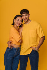 Young multiracial couple hugging while smiling together