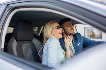 Shot of a cheerful beautiful couple driving in a car together and enjoying in the road trip.