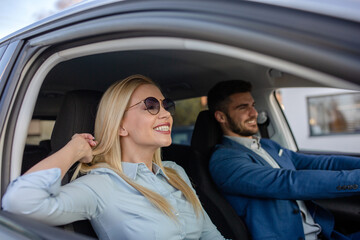 Fototapeta premium Shot of a cheerful beautiful couple driving in a car together and enjoying in the road trip.