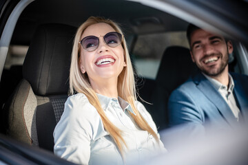 Shot of a cheerful beautiful couple driving in a car together and enjoying in the road trip.