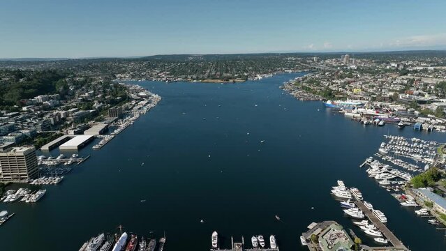Wide drone shot of Lake Union in Seattle on a warm summer day filled with boats.