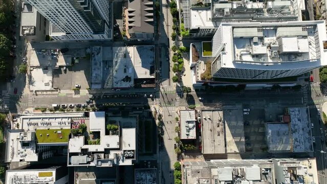 Drone shot looking down at Seattle's bustling streets with building after building filling the blocks.