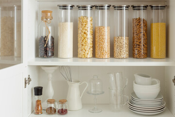 organization of food storage in the kitchen.  Collection of grain products in storage jars in pantry, zero waste smart kitchen organization
