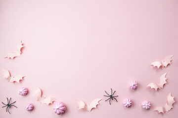 pink background with a place for text with small pink pumpkins with pink bats spiders skeletons...