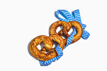 Fototapeta premium Oktoberfest concept - pretzels on a traditional napkin isolated on white background