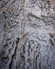 Sand in the surf zone to erode stone