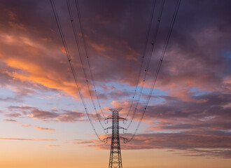 high voltage towers pylon on sunset background