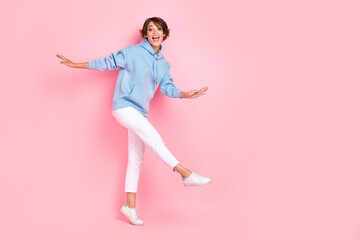 Fototapeta na wymiar Full length photo of pretty nice lady wear stylish blue clothes go empty space enjoy free time relax rest isolated on pink color background