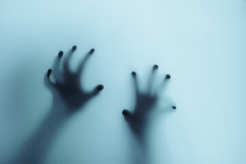 Shadow of a zombie hand on white background.