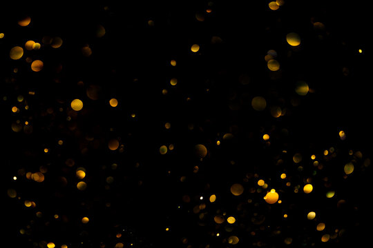 Golden glitter bokeh sparkles lights dark abstract texture overlay background