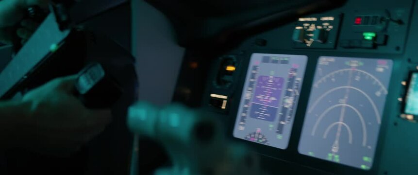 CU Commercial aircraft pilot controling the airplane during the flight, high turbulence. View from inside the cabin. Real aircraft, nighttime shot