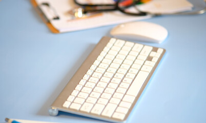 Doctor's office panoramic banner, physician's therapist's office with stethoscope in focus closeup, health care, medicine, medical insurance concept.