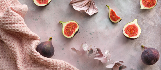 Panoramic banner Autumntime background with fresh halved fig fruits. Dry eucalyptus and cala lily...