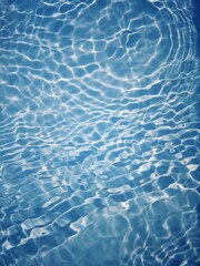 Bluewater waves on the surface ripples blurred. Defocus blurred transparent blue colored clear calm water surface texture with splash and bubbles. Water waves with shining pattern texture background.