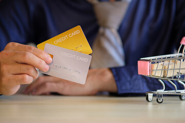 E-commerce and online shopping concept, Man's hand is holding a credit card for online shopping...