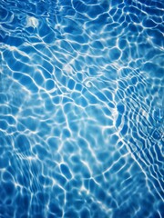 Defocus blurred transparent blue colored clear calm water surface texture with splashes and bubbles. Trendy abstract nature background. Water waves in sunlight with copy space. Blue watercolor shining