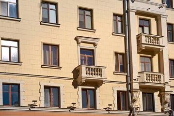 Fototapeta na wymiar Balcony with with balustrade, old residential building. Stalinist architecture, building on Independence Avenue in Minsk. Stalin Empire style. Balcony of soviet building.