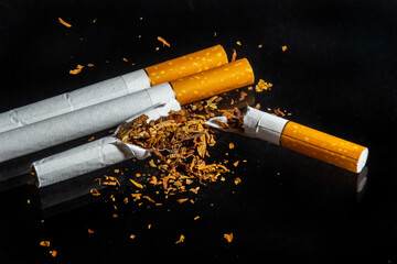 World No Tobacco Day, Broken cigarette isolated on black background. No smoking concept