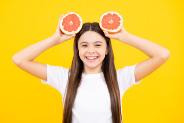 Happy teenager girl in t-shirt hold grapefruit orange, kids fruits vitamin. Happy teenager portrait. Smiling girl.