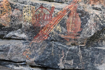 Aboriginal rock art: faded barramundis-red turtle-yellow goanna. Ubirr-Kakadu-Australia-185