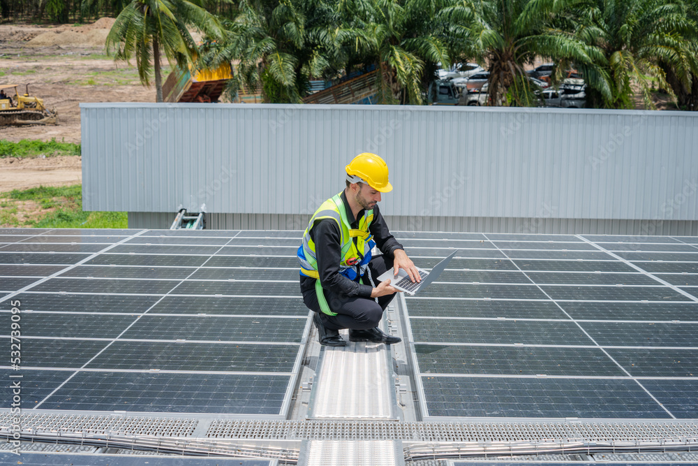 Poster Professional worker installing and checking solar panels on the roof of a factory,Innovative solution for energy solving. Use renewable resources. Green energy.