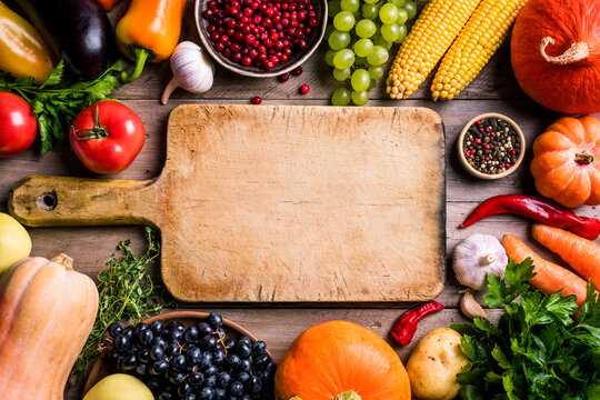 Organic vegetables and empty cutting board