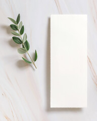Vertical card on a marble table decorated with eucalyptus branches top view, Wedding mockup