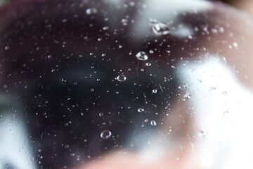 Abstract image obtained from slime modeling, with a large and transparent bubble and other smaller...