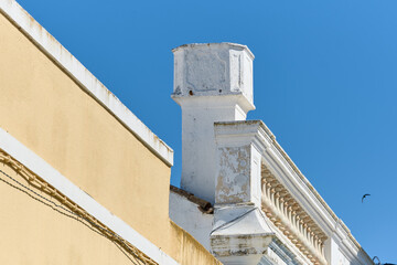 Fototapeta na wymiar Traditional chimney on the roof of a houses in Olhao, Faro district, Algarve, Portugal