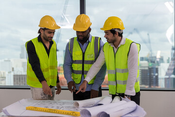 Team Engineers with draft plan of building on constructing site. Engineer work on site. engineer...