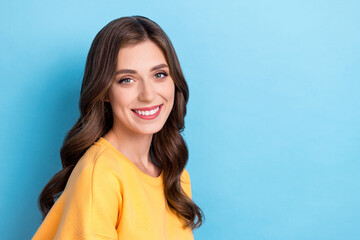 Photo portrait of stunning young woman toothy smile shopping promo banner wear trendy yellow garment isolated on blue color background