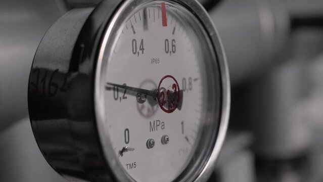 Upward movement of the pressure gauge arrow as the unit pressure increases in production. Close-up 