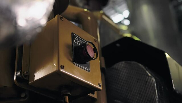 Industrial plant worker presses the big red button to stop the machine. Close-up