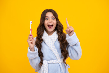 Amazed teen girl. Oral hygiene, dental. Teenage girl brushing her teeth. Teen holds a toothbrush in...
