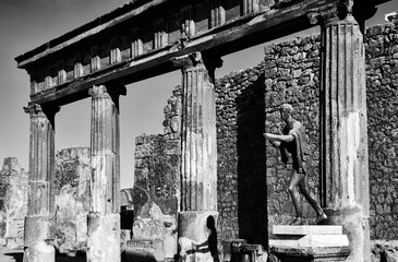 Pompeii ruins. Apollo temple. Italy tourism background. Heritage, culture, past concepts. Abstract time motion. Game of light and shadow. Black white historic photo.