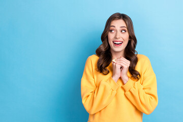 Photo portrait of stunning young lady look excited admire empty space promo wear trendy yellow clothes isolated on blue color background