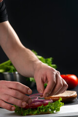 Detail view of chef serving burgers